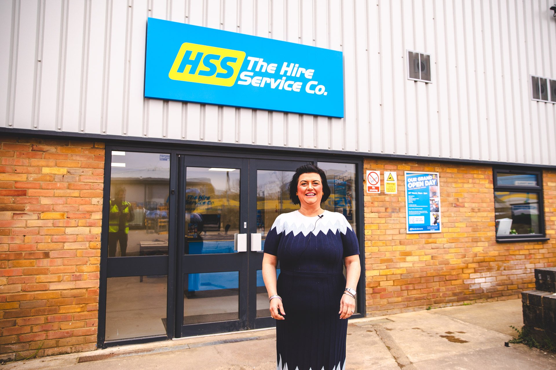 Emma Graves stands outside a The Hire Service Company branch, reflecting her leadership role and commitment to driving success across the business.