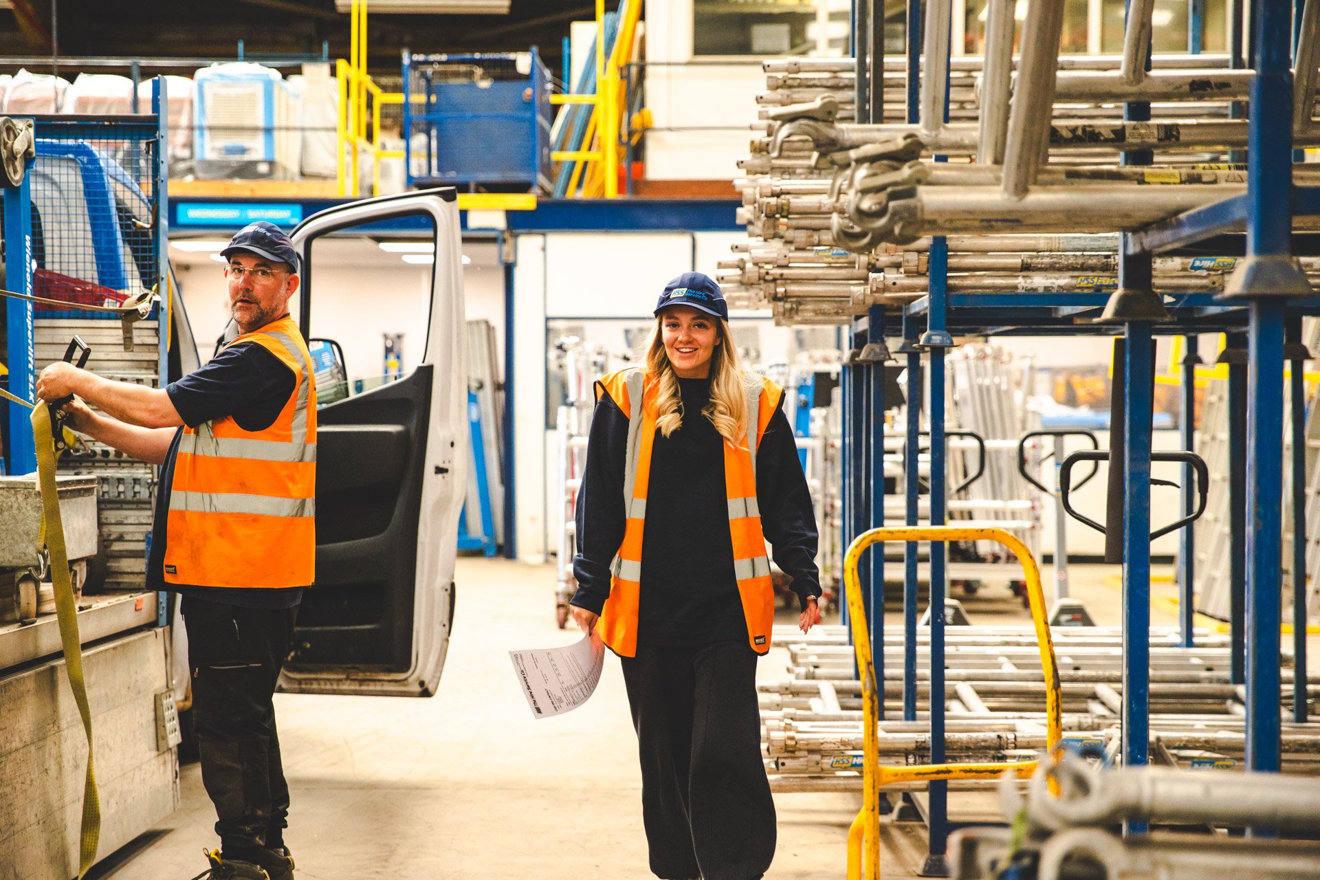 Women in hire working alongside colleagues in an HSS equipment hire warehouse.